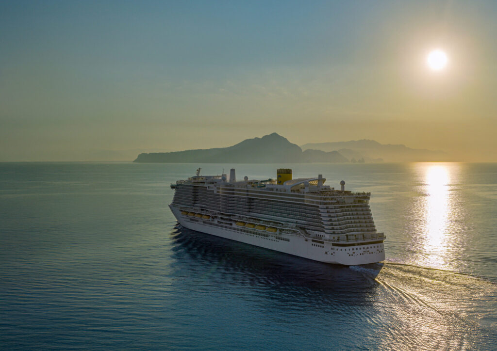 Vista aérea del crucero Costa Smeralda navegando en el mar Mediterráneo durante un atardecer dorado de camino a las islas Baleares.